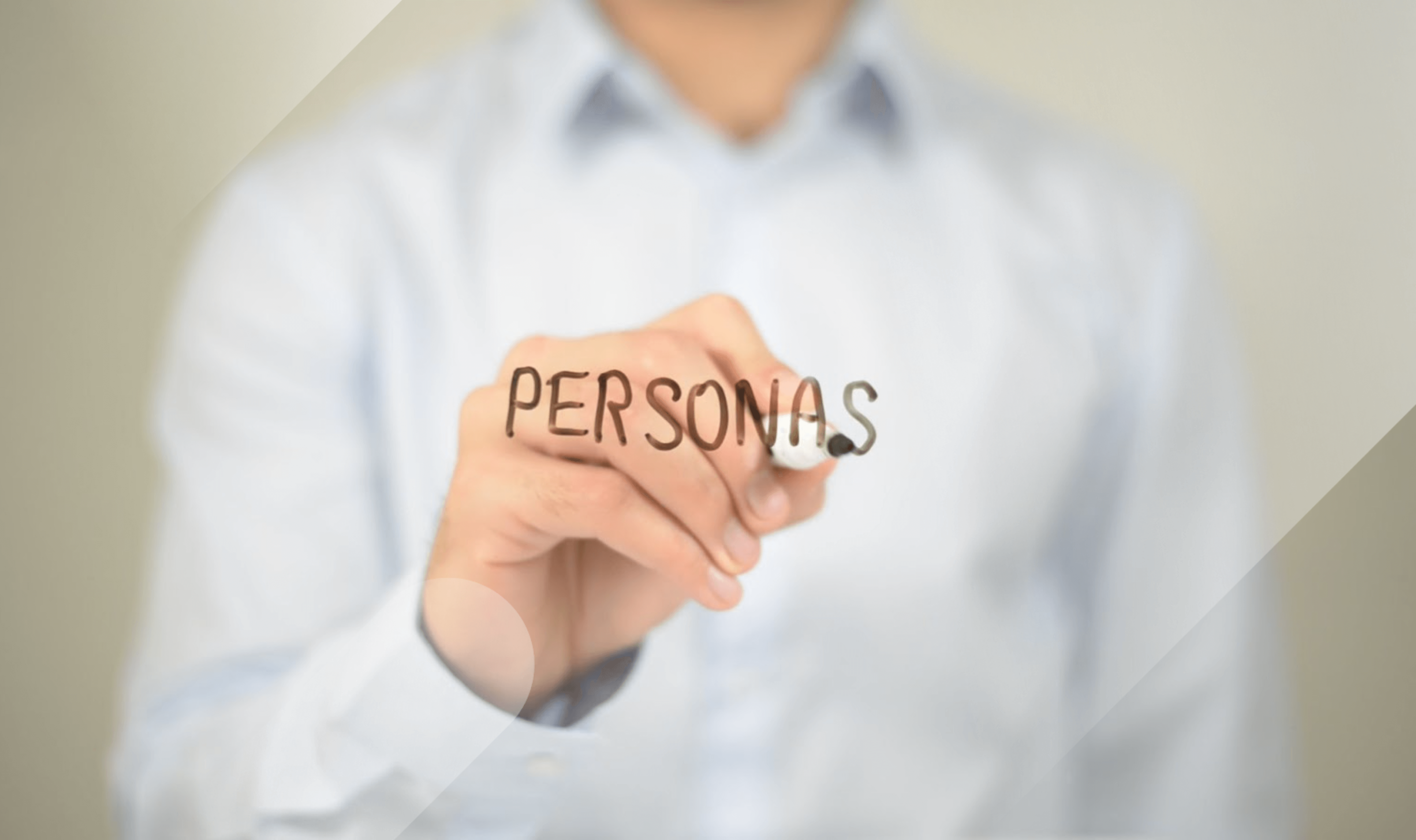 Man in a collared white shirt writing personas on a see through board representing buyer personas