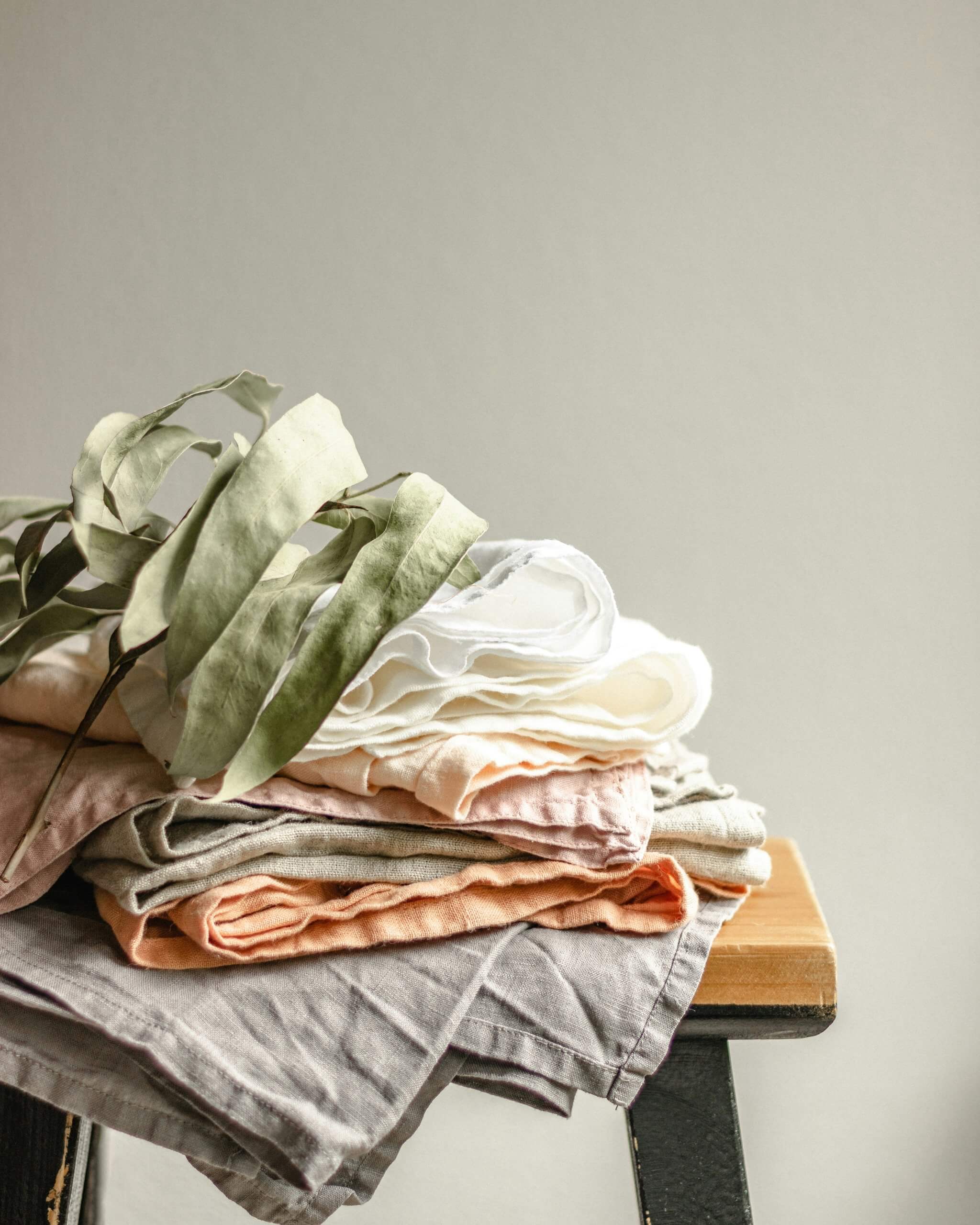 Picture of a pile of clothes on a stool.